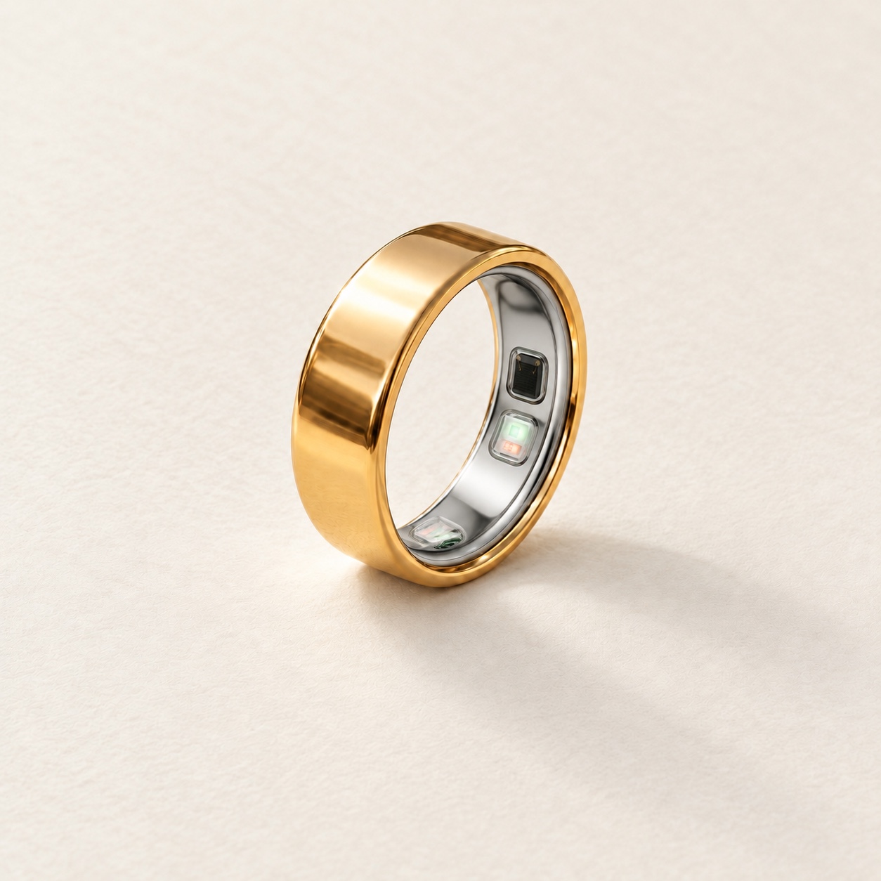 Upright gold jacket in warm daylight on ivory paper, with the corrected Oura Ring 5 sensor design.